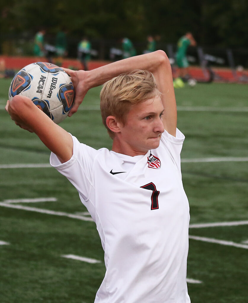 Marshall senior Matin Holloway winds up for a throw in during an away game against Rock Bridge